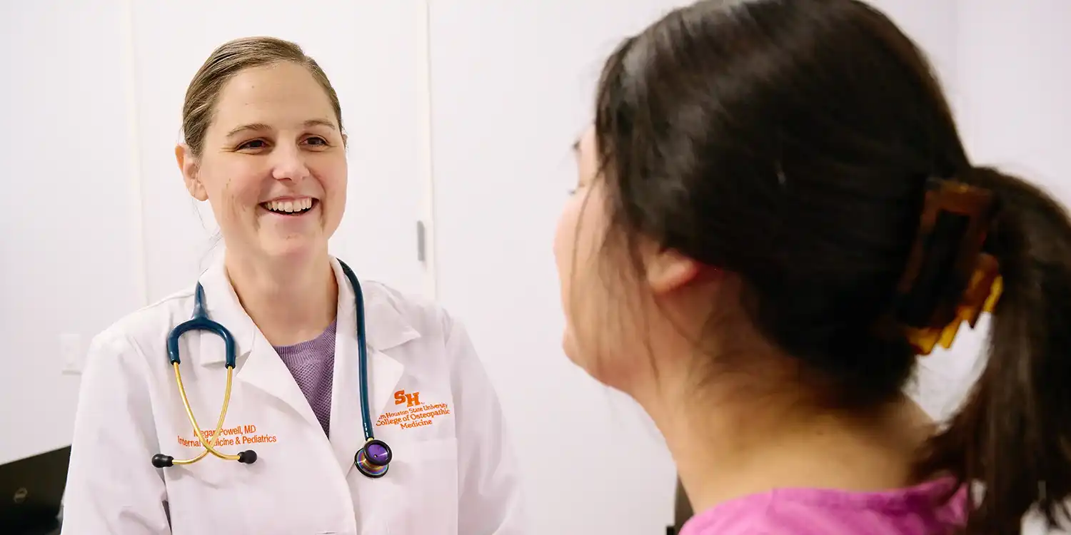 Physician examining a patient in an exam room at a doctor’s office