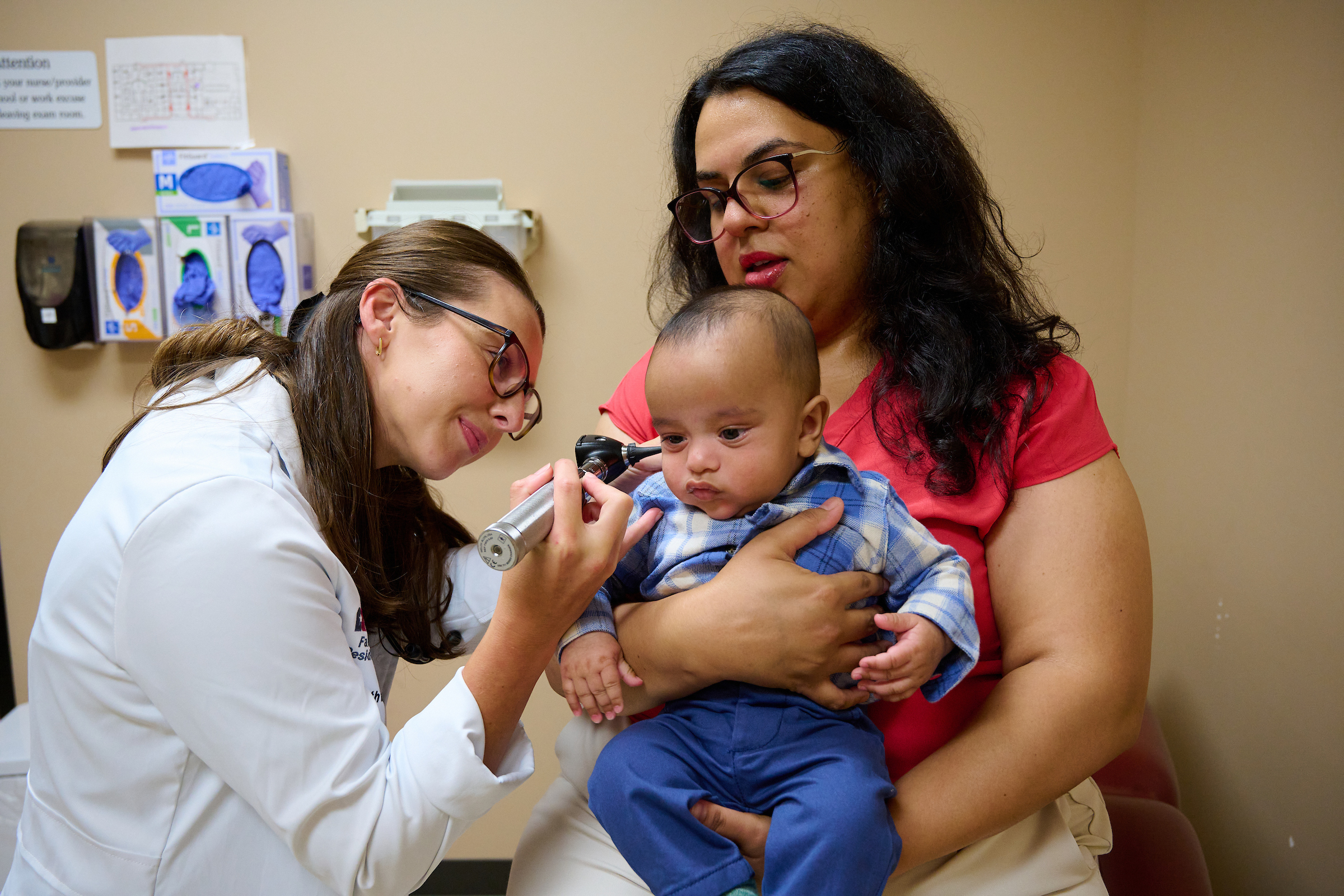 newborn with residents at doctor's office in Conroe