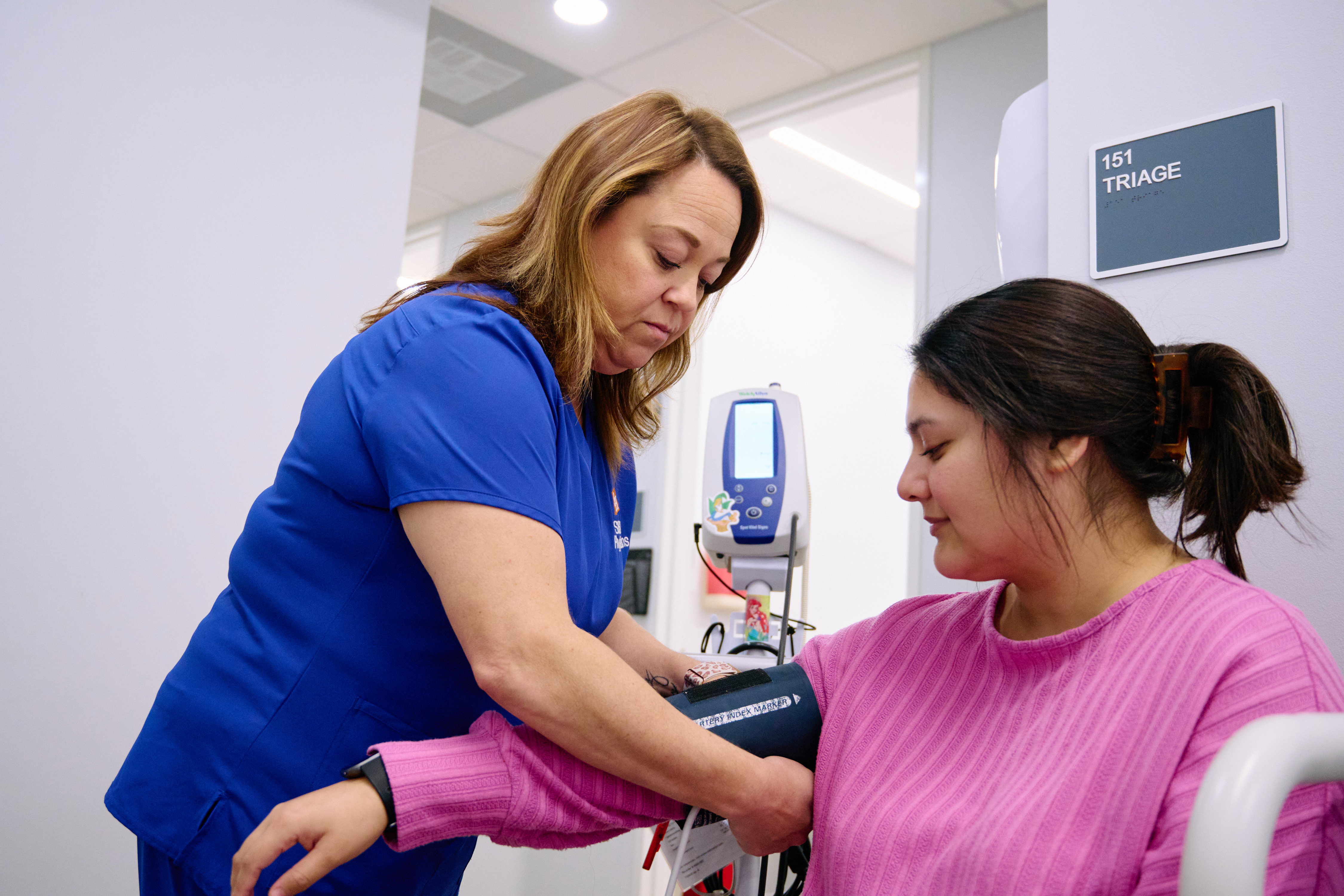 Nurse checking patient’s blood pressure at SHSU Physicians before a physical.